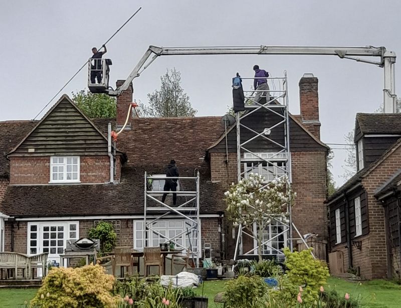 The Roof Moss Cleaners using cherry picker and scaffolding to clean roof safely and professionally in Flitwick, Bedfordshire
