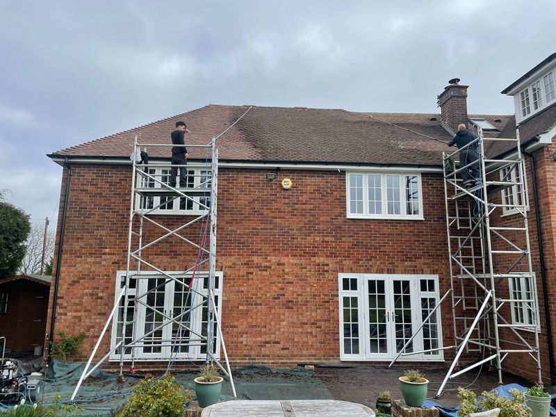 Roof cleaning carried out safely from scaffold towers by The Roof Moss Cleaners in Flitwick